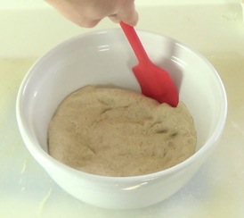 unsticking the dough from the sides of the bowl
