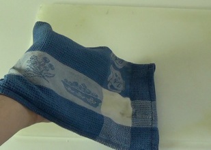 damp dishcloth to keep the kneading board from moving