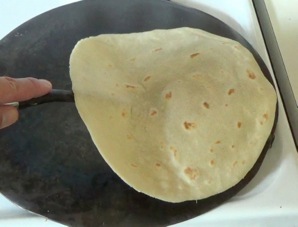 taking the tortilla off the griddle