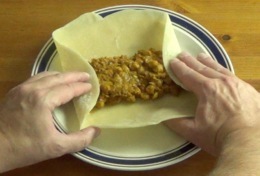 folding the tortilla over the filling