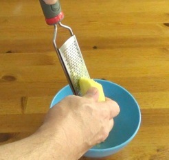 grating ginger with a microplane grater