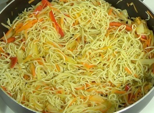mixing the noodles and vegetables