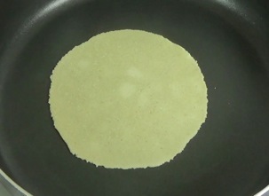 tortilla cooking on the second side