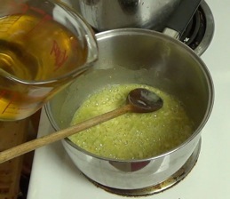 adding stock and wine to make a sauce