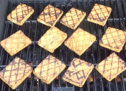 flipping the tofu on the grill
