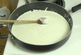 cashew/soy milk mixture in the skillet with olive oil and garlic