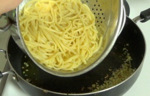 adding pasta to pan