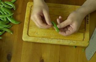 peeling the strings off sugarsnap peas