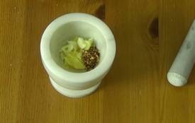 garlic, ginger, and red pepper flakes, in a mortar and pestle