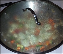 vegetables in a wok with a lid
