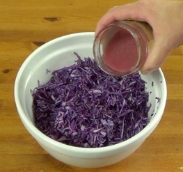 pouring dressing on coleslaw