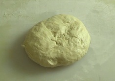 risen dough on a kneading board