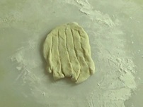 making vertical slices through the dough