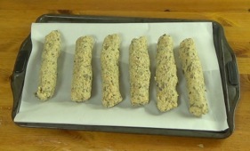 sausages on a parchment covered baking sheet